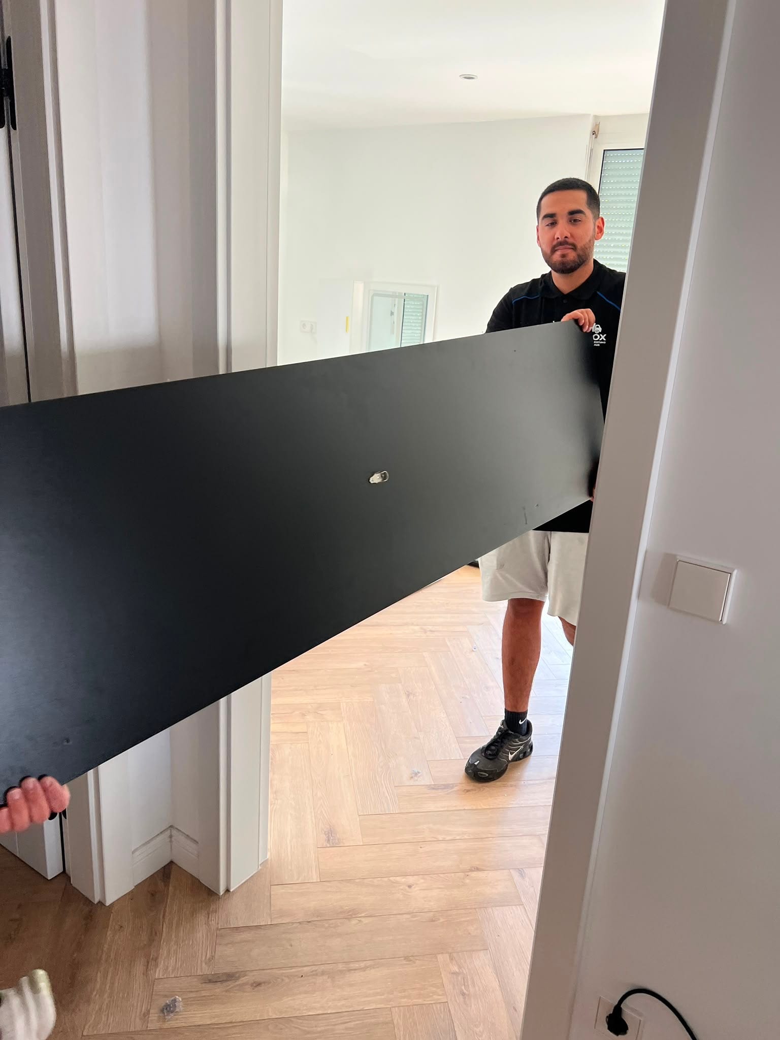 Schrankteile werden durch die Tür in die neue Wohnung getragen